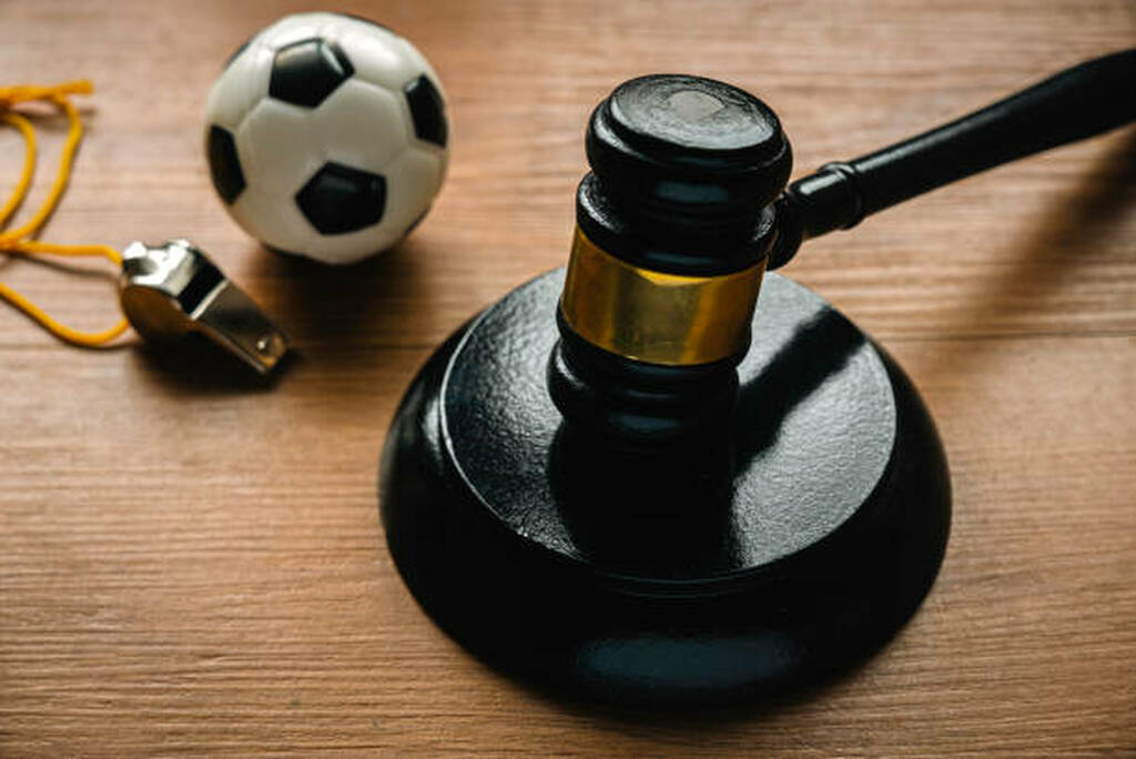law and soccer sport.football coach accused. concussion lawsuit.